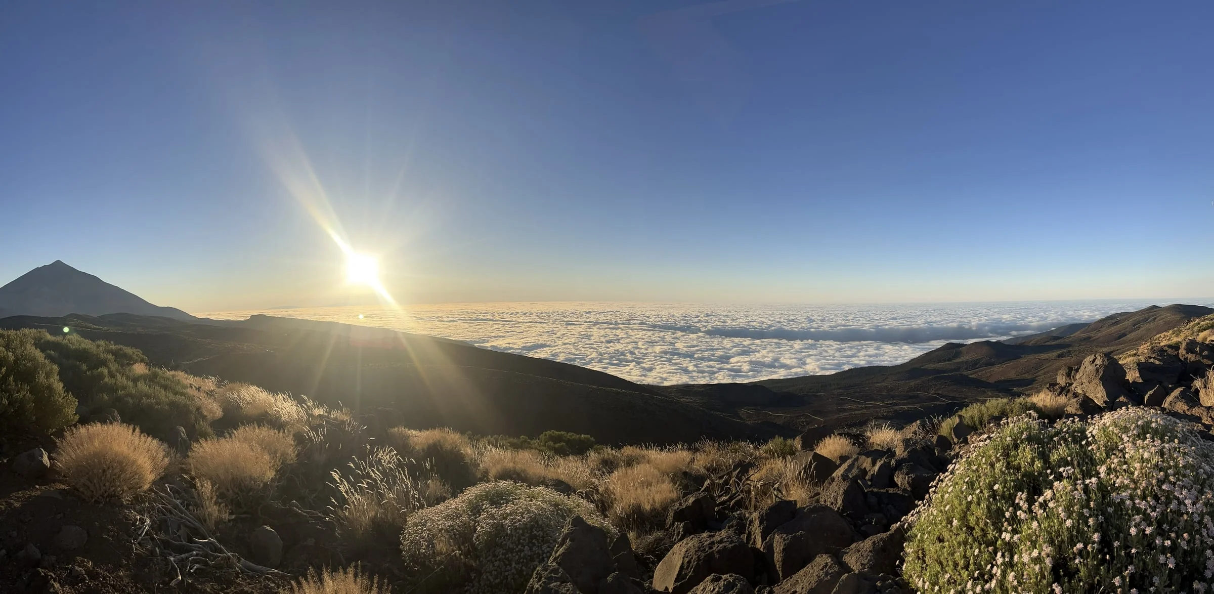 Sunrise over mountains above the clouds